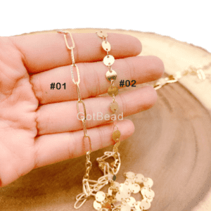 Hand Holding Gold Paper Clip Chain and Disc Link Chain